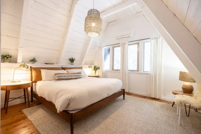 The primary bedroom upstairs features a super cozy king sized bed and is located on the second level, just off of the office and workout area. Great forest views, and a full bath is just down the hall on the same level