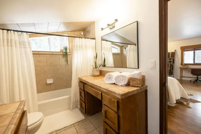 The primary bedroom features an ensuite bathroom with mountain views from the large shower.