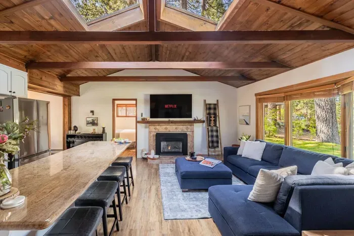 The living area looking from the hallway; the primary bedroom's door is just visable to the left of the fireplace.