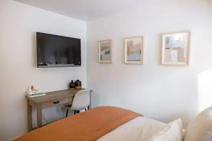 Bedroom number three has a work station as well as a flatscreen smart tv.