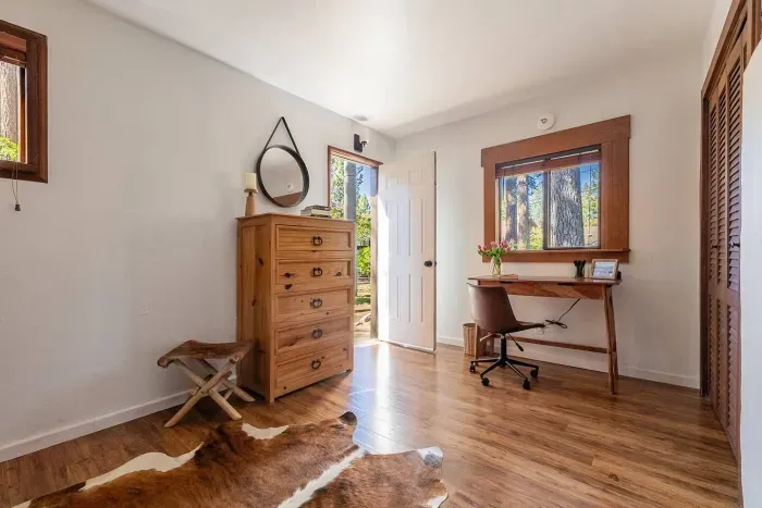 Our primary suite has its own dedicated workspace, in addition to closet, chest of drawers, and direct access the the front yard