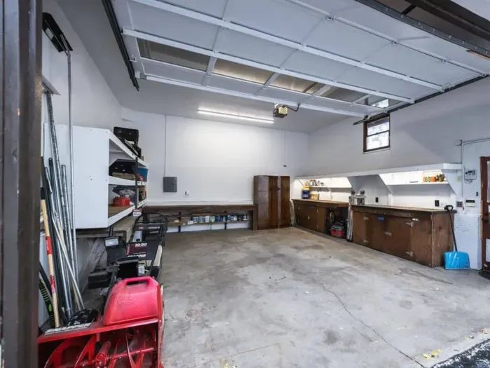 The garage features 18 foot ceilings which could store a boat if needed during the summertime or snowmobiles during the wintertime. 

Otherwise, park your car(s) in here so you don't have to worry about removing snow off of your car before leaving.
