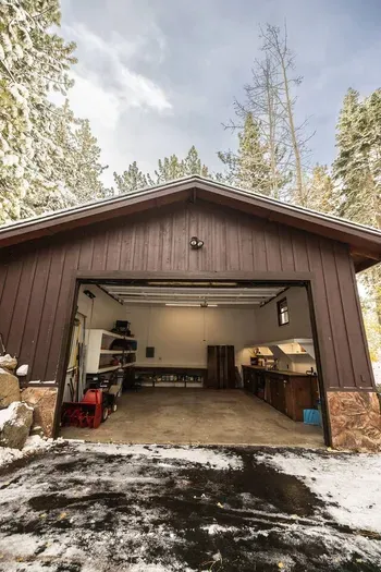 Two car garage with plenty of storage and a waxing station to tune your skis or board in the winter.