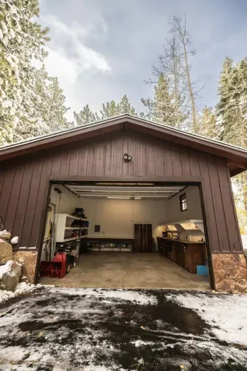 Two car garage with plenty of storage and a waxing station to tune your skis or board in the winter. 