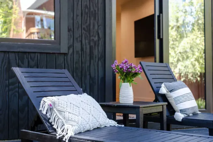The primary bedroom downstairs features sun loungers on the deck.