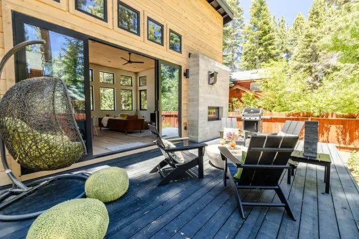 The back patio features plenty of comfortable seating, a BBQ, and a dual-sided natural gas fireplace!