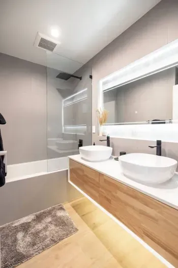 Upstairs bathroom shared by bedrooms the third and forth bedrooms, including dual vanity sinks and a large tub + shower combination