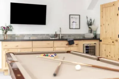 Newly re-felted pool table, large flat screen TV and wet bar with mini fridge in our game room