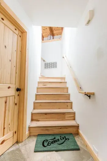 Main Entryway up to living area, kitchen, upper bedrooms and upper decks. The Largest bedroom is just through the door on the right. 