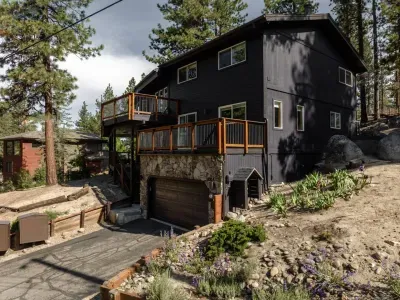 View of our home and driveway/parking area. This home does have 3 levels and requires stair access to get to all of them