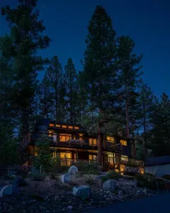 The Mountain Haus at dusk-set on the edge of the Tahoe National forest, with three large decks and room for the entire family!