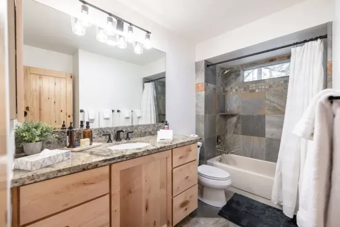 This bath is in the hallway with the three upstairs king bedrooms. Shower with tub + large vanity