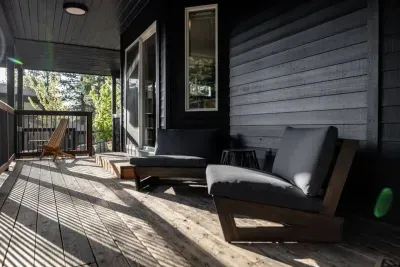 Our lower deck is also south facing, and covered, for those that like it a bit cooler! The entrance to the primary suite is just through the sliding glass doors and the  spa is just past the railing in the background, to the right