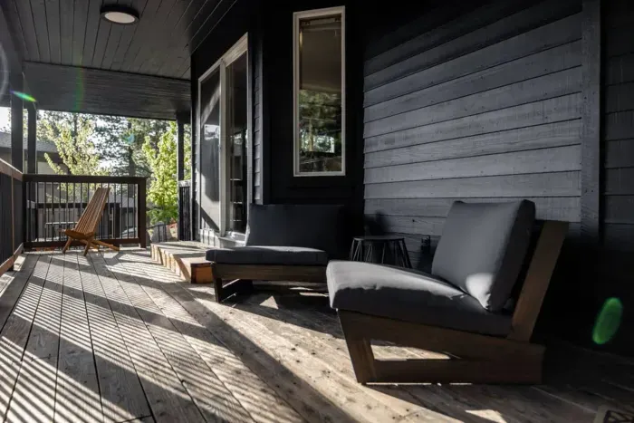 Our lower deck is also south facing, and covered, for those that like it a bit cooler! The entrance to the primary suite is just through the sliding glass doors and the  spa is just past the railing in the background, to the right