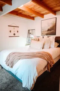 The front bedroom is light and bright, directly facing a view of the forest and features a queen size bed. Also available in this room is a small dresser and armoire, along with plenty of reading material