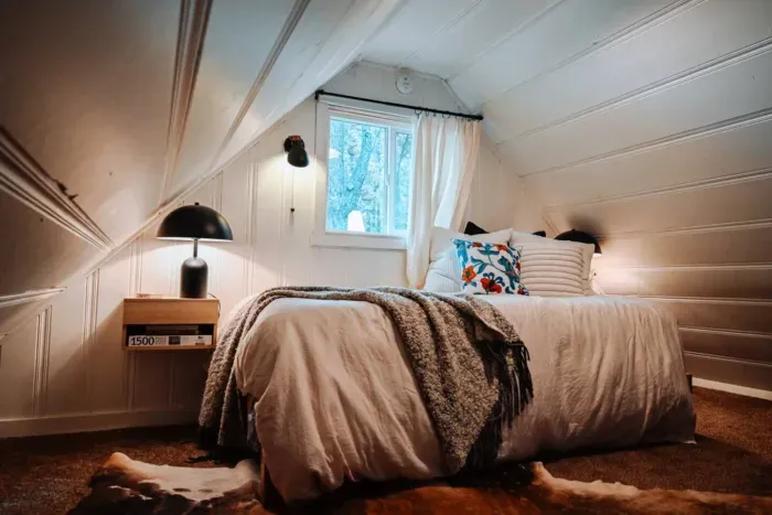 The loft features a twin XL bed and cozy linens, plus a small desk perfect for work from home (if you have to!) 