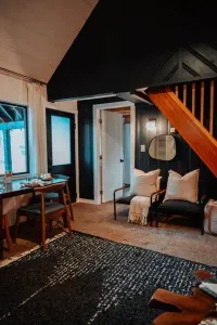 View from the living room towards the front bedroom, dining area plus the front door to the cabin.