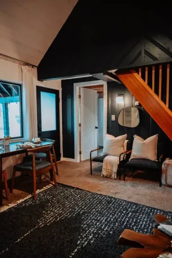 View from the living room towards the front bedroom, dining area plus the front door to the cabin.