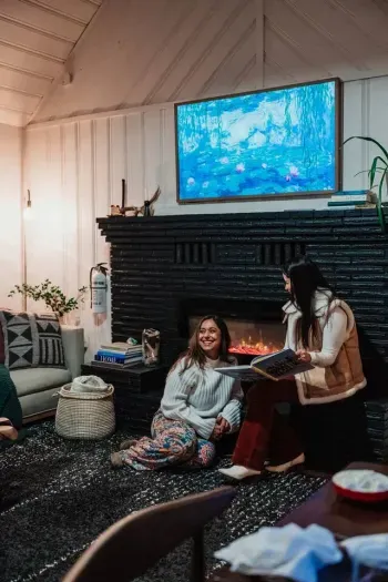 You might have to fight over this cozy spot right in front of the electric fireplace 