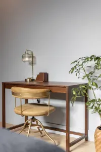 The downstairs primary bedroom now features a desk and chair for those work from home trips.