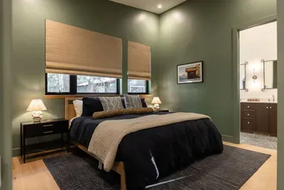 The second spacious primary  has extra high ceilings, a large closet, a King-sized bed. The ensuite bath has a walk-in shower and double vanity. We supply Public Goods shower essentials and Sparta Candle Co. lotions + soaps.
