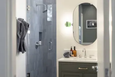 The fourth full bathroom at The Lake Trail Lodge, located at the top of the stairs,  has a spacious walk-in shower and a few steps away from the 4th bedroom. Everyone gets their own bathroom, and each is stocked with Public Goods shower essentials.