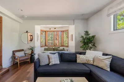 Our second living room, complete with comfortable sectional sofa, additional seating by the bay windows, and plenty of books and games.