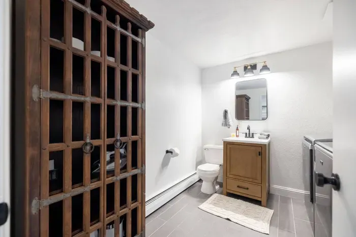 The half bath further down the hallway is also the laundry room