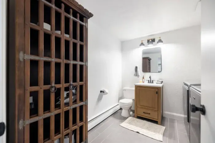 The half bath further down the hallway is also the laundry room