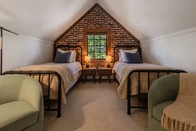 Bedroom #6 features two twin beds, each with a little seating area.