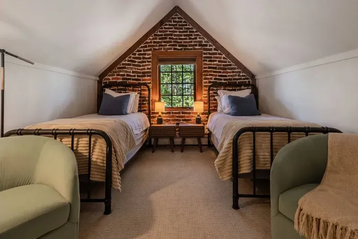 Bedroom #6 features two twin beds, each with a little seating area. 