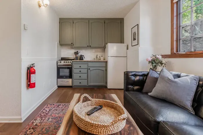 Here is the kitchenette in the mother-in-law unit, which features a stove, a small refrigerator, and a pour-over coffee setup.
