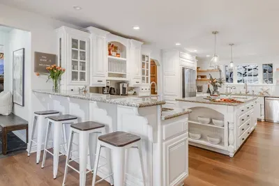 The kitchen layout allows for multiple people to help out while also being able to visit.