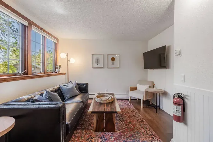 The living room in the mother-in-law unit features a smart TV, seating area, sofa and coffee table-plenty of room to spread out!  