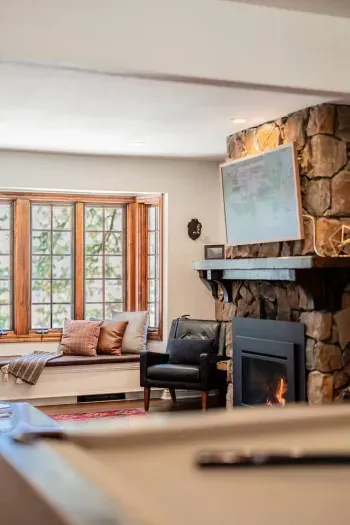 The primary living room is on the main level and looks out into the quiet neighborhood and forest.