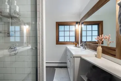 Bathroom #2 is located in the hallway across from Bedroom #2 and next to Bedroom #3.