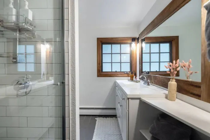 Bathroom #2 is located in the hallway across from Bedroom #2 and next to Bedroom #3.