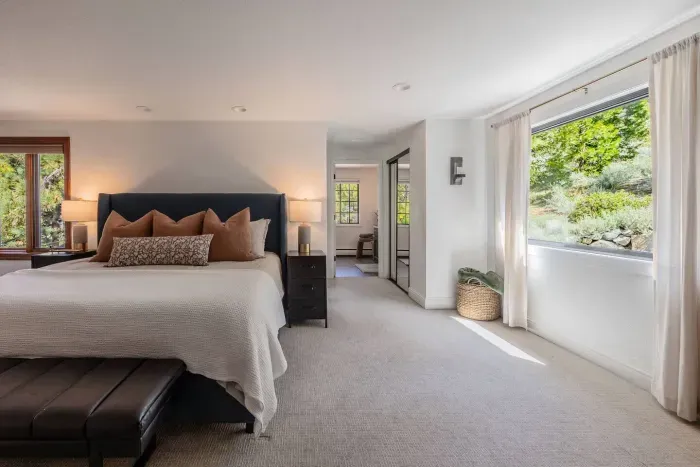 More angles on the primary bedroom, with a peek into the ensuite bath. 