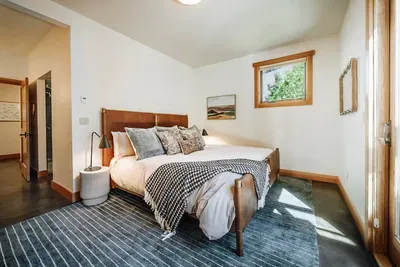 Our primary suite features a kind sized bed, ensuite bath with soaking tub and walk-in shower, double vanity sinks and direct access to the hot tub and backyard. There's also a large walk-in closet along with a pack 'n play for the littlest guests.