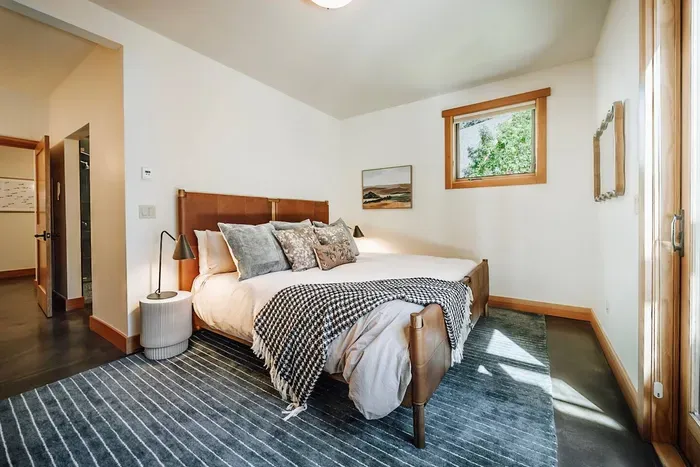 Our primary suite features a kind sized bed, ensuite bath with soaking tub and walk-in shower, double vanity sinks and direct access to the hot tub and backyard. There's also a large walk-in closet along with a pack 'n play for the littlest guests.