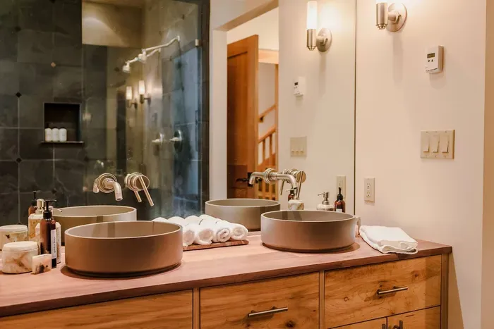 Dual vanity sinks, an amazing walk in shower and a soaking tub make the primary suite's bath an experience. We feature soaps and lotions from Sparta Candle Co & shower essentials from Public Goods for a stress free packing: just come ready to relax!