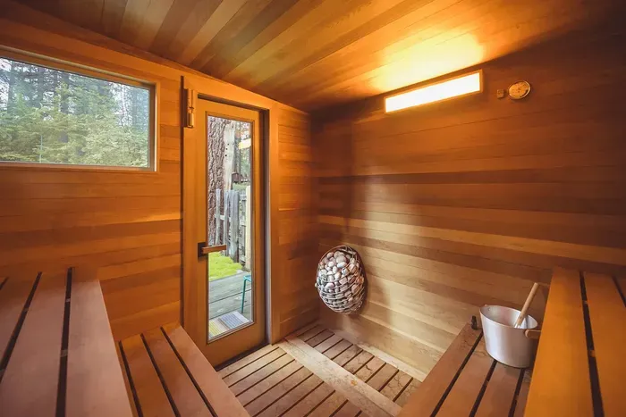 Our custom built sauna heats up quickly and looks towards the backyard and Tahoe forest. Photography by @heypamcakes