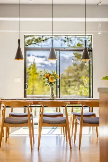 Our dining table features enough room for your entire group plus stunning views of the mountains and forest. 