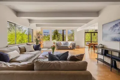 Did we mention the views?!  There's not a bad seat in the house, and our living room has tons of available seating for your entire group. Each of our large  windows features a different forest or mountain view, making you feel immersed in nature.