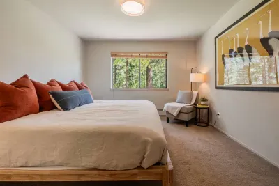 Our downstairs bedroom which features a king size bed, larger closet with dresser, seating area and a view of the forest. The downstairs bathroom is just steps away.