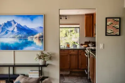 The view from the living room looking into the kitchen. We've just installed a 75" CanvasTV and have plenty of games and books available for your stay. Looking for a specific game or book? Just ask-we may be able to source it before your stay!