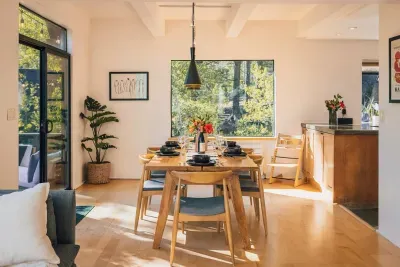 The dining room with forest views, plenty of seating for 6 and high chair available for your use. Easy access to both the back deck and the kitchen! 
photography by @heypamcakes