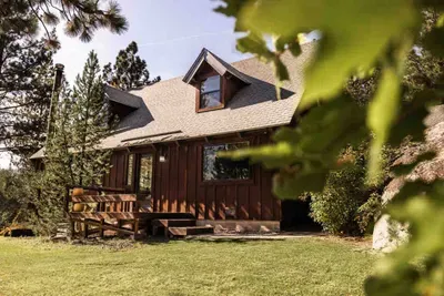 A peak at the front door and patio of Echo View Chalet. In addition to the forest, there is an ample sized lawn surrounding our home!
