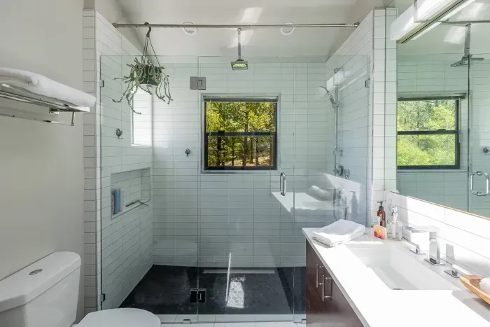 Our ensuite bathroom features a walk in rain shower with forest views and double vanity for convenience. 