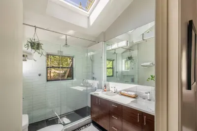 The primary ensuite bath is located on the second level. Large walk in shower with dual shower heads, double vanity and extra large skylight. We provide Sparta Candle co lotions and soaps as a special treat for you.